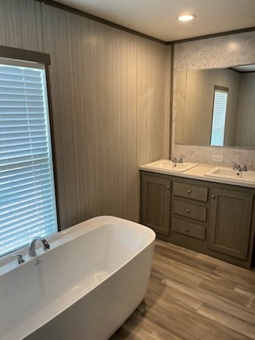 755 Orchard, Ellijay, GA 30540 - bathroom with a soaking tub, double vanity, wood finished floors, and wooden walls