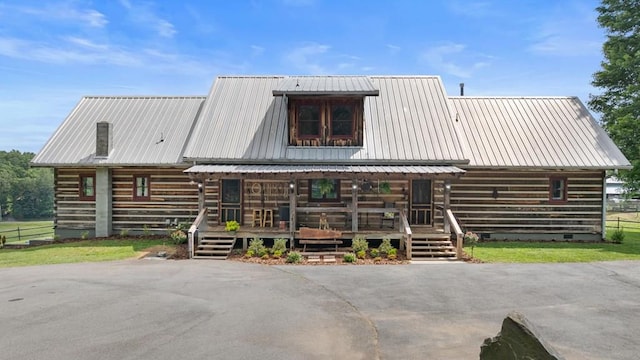 102 Cross Creek Ln, Warne, NC 28909 - view of front of house with covered porch, log exterior, a metal roof, and crawl space