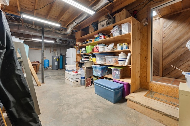 102 Cross Creek Ln, Warne, NC 28909 - unfinished below grade area with freestanding refrigerator, a water pressure tank, and electric water heater