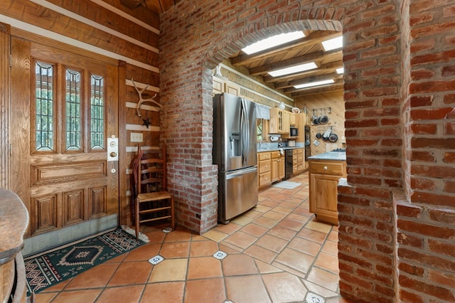 102 Cross Creek Ln, Warne, NC 28909 - kitchen featuring stainless steel refrigerator with ice dispenser, wood walls, beamed ceiling, light countertops, and light tile patterned floors