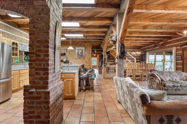102 Cross Creek Ln, Warne, NC 28909 - living room with wood walls, a wood ceiling with exposed beams, light tile patterned floors, and a chandelier
