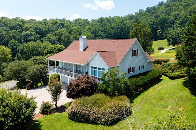 birds eye view of property featuring a view of trees