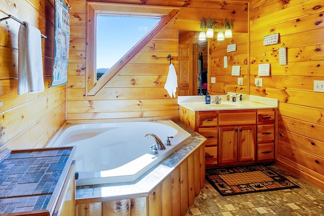 bathroom with vanity, a tub to relax in, and wooden walls