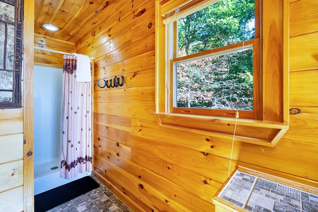 bathroom with wood ceiling and wooden walls