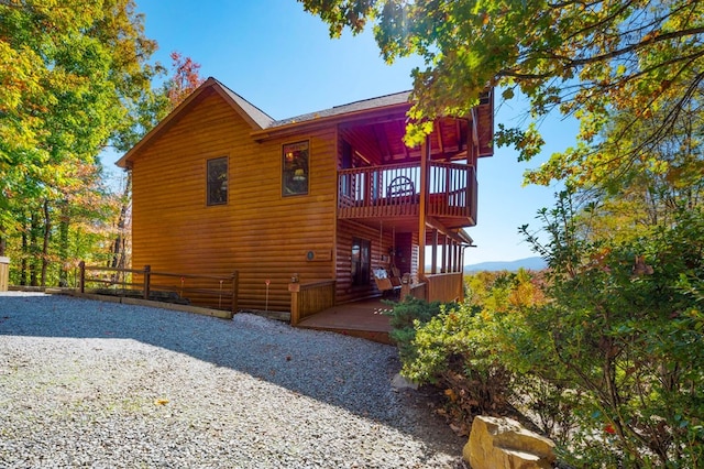 rear view of house featuring a deck