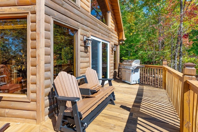 wooden terrace featuring a grill