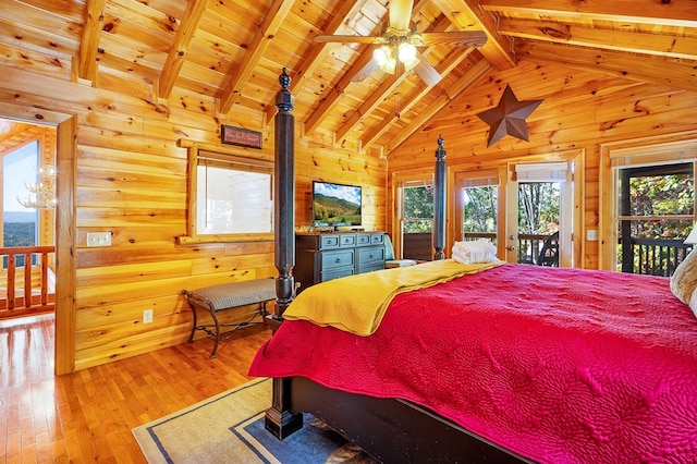 bedroom with access to exterior, light wood-type flooring, beamed ceiling, and wooden walls