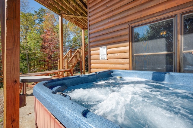 wooden deck featuring a hot tub