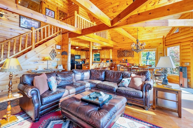 192 Oak Ridge Way, Morganton, GA 30560 - living area featuring wooden walls, a chandelier, stairs, wood finished floors, and high vaulted ceiling