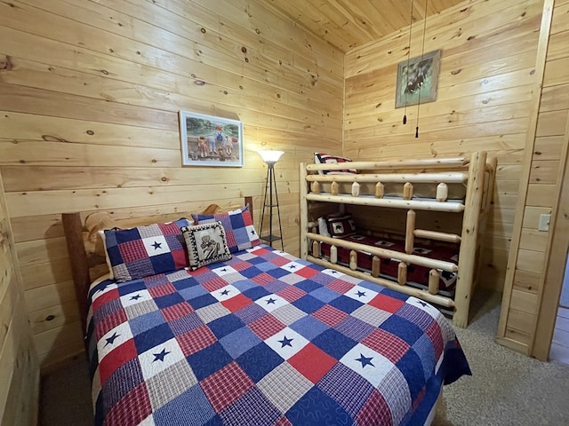 bedroom with wood walls, wood ceiling, and carpet floors