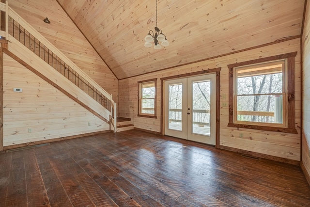 foyer with french doors, dark wood-type flooring, a notable chandelier, and lofted ceiling