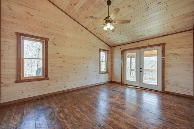 empty room featuring lofted ceiling, ceiling fan, dark wood-type flooring, wooden ceiling, and french doors