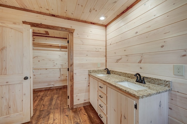 bathroom featuring hardwood / wood-style flooring, vanity, wood walls, and wooden ceiling