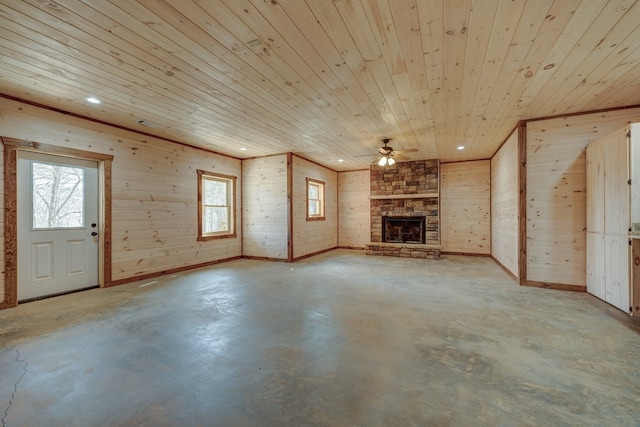 unfurnished living room with ceiling fan, wood ceiling, and a fireplace