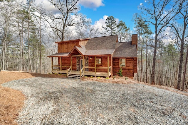 log home featuring covered porch