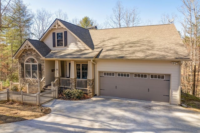 view of front of property with a garage and covered porch