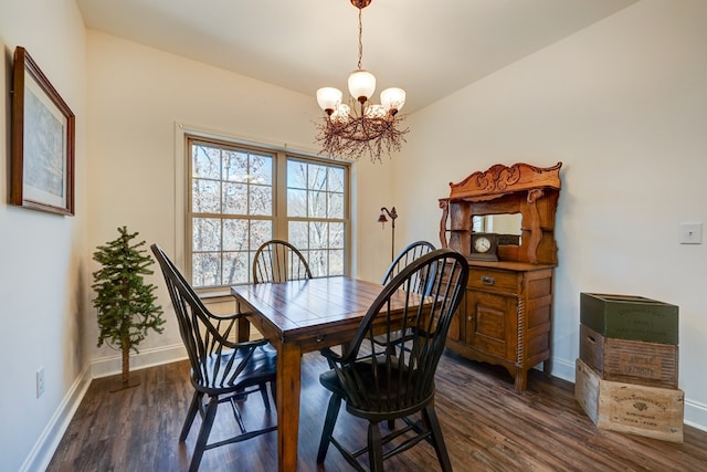 dining space with an inviting chandelier and dark hardwood / wood-style flooring