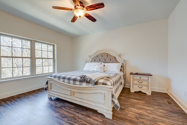 bedroom with dark hardwood / wood-style floors and ceiling fan