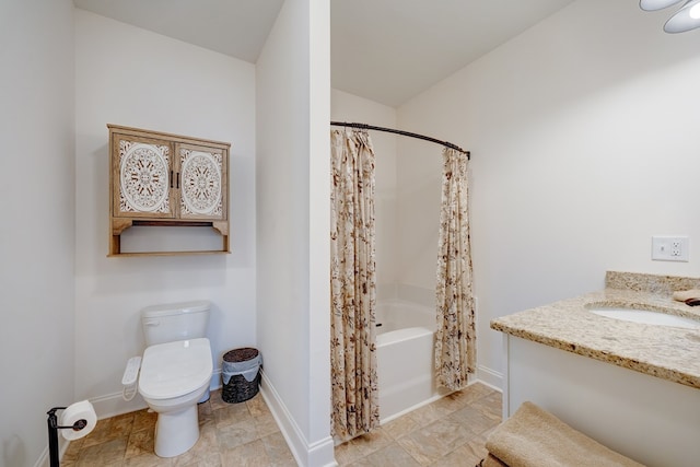 full bathroom with vanity, shower / tub combo with curtain, and toilet