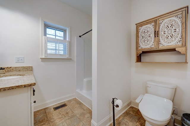 bathroom with walk in shower, vanity, and toilet