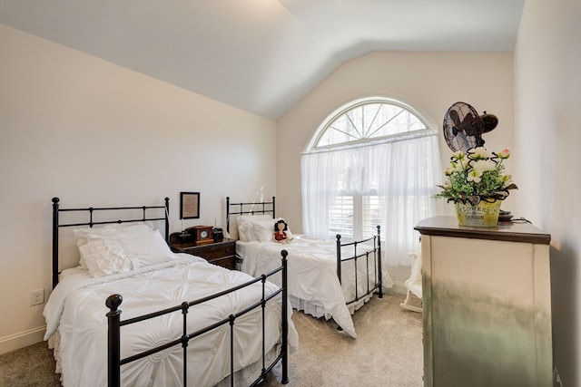 bedroom featuring vaulted ceiling and carpet floors