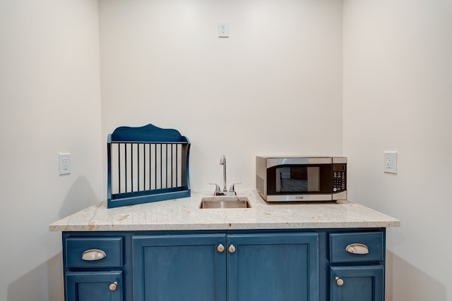 interior space featuring sink and blue cabinetry