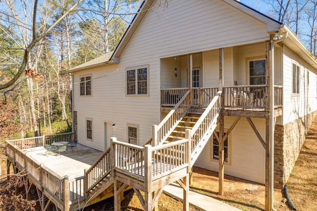 back of property with a wooden deck