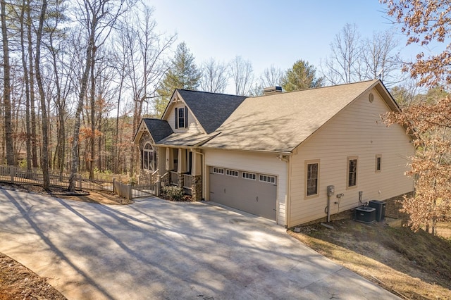 view of front of home featuring a garage and central air condition unit