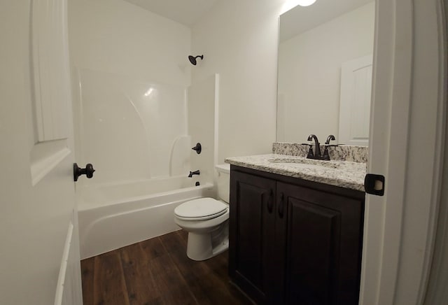 full bathroom with shower / bathing tub combination, toilet, vanity, and hardwood / wood-style flooring