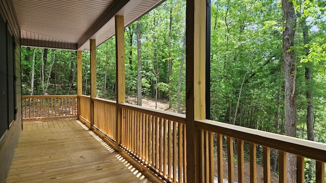 wooden deck featuring a forest view