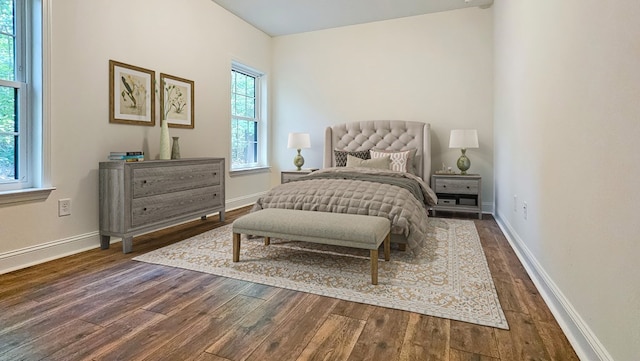 bedroom with dark wood-type flooring and baseboards