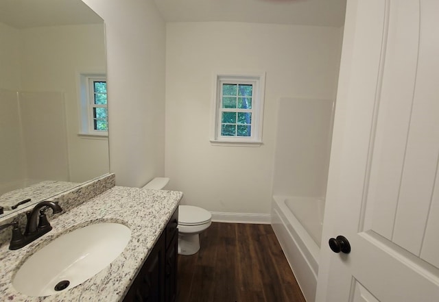 full bathroom with toilet, baseboards, plenty of natural light, and wood finished floors