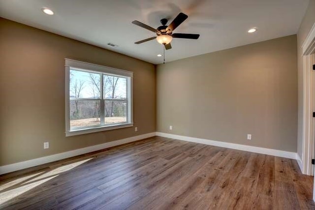 empty room featuring ceiling fan and hardwood / wood-style flooring