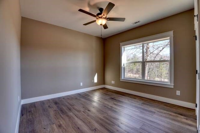 spare room with hardwood / wood-style floors and ceiling fan