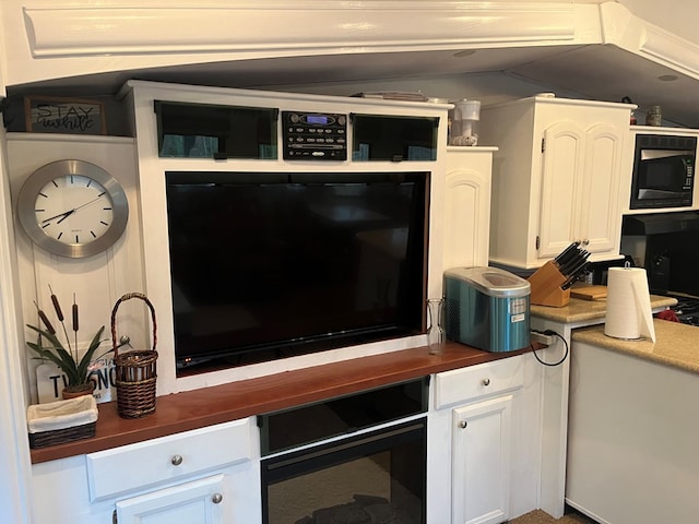 142 Gander Gap Rd, Hiawassee, GA 30546 - kitchen featuring built in microwave, butcher block countertops, beverage cooler, lofted ceiling, and white cabinetry