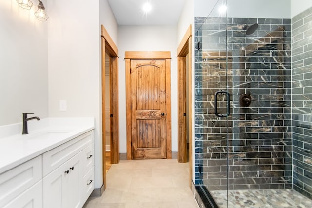 bathroom with vanity, tile patterned floors, and a shower with door