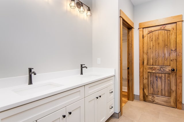 bathroom featuring tile patterned flooring and vanity