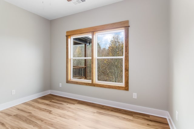 empty room with ceiling fan and light wood-type flooring