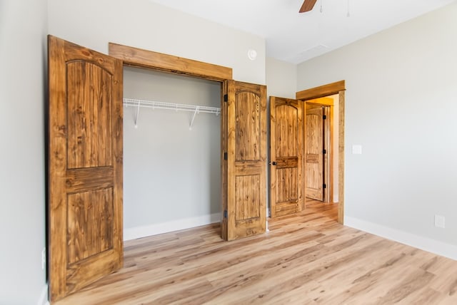 unfurnished bedroom with light wood-type flooring, a closet, and ceiling fan