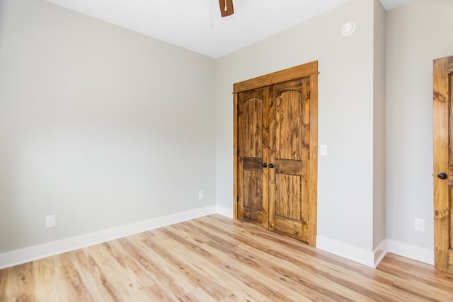 unfurnished bedroom featuring ceiling fan and light hardwood / wood-style flooring