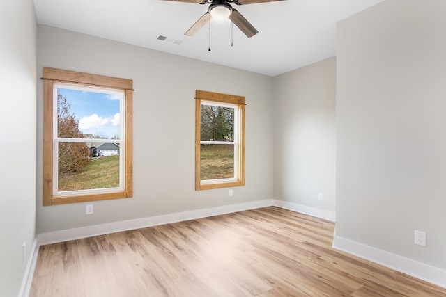 empty room with ceiling fan and light wood-type flooring