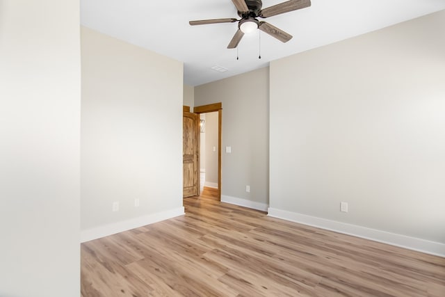 empty room with ceiling fan and light hardwood / wood-style floors