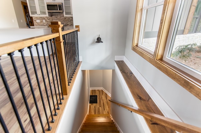 stairway featuring hardwood / wood-style flooring