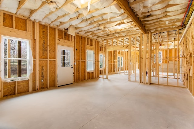 misc room with a healthy amount of sunlight and concrete floors