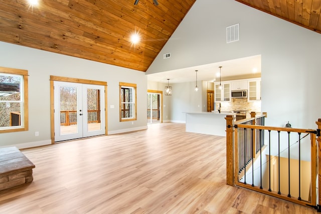 living room with french doors, light hardwood / wood-style floors, high vaulted ceiling, and wood ceiling