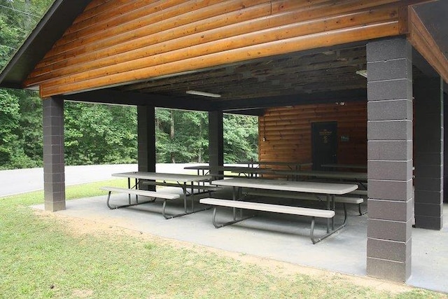 view of community with outdoor dining area and a patio area