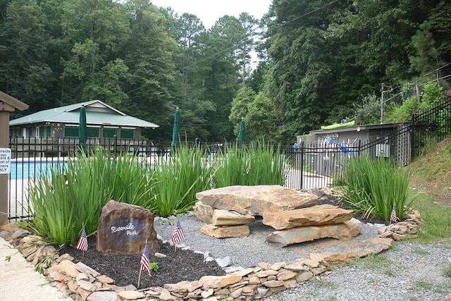 view of yard featuring a community pool and fence