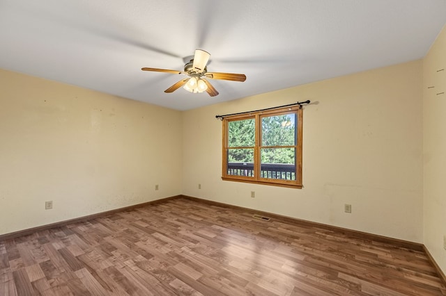 spare room featuring ceiling fan and hardwood / wood-style floors