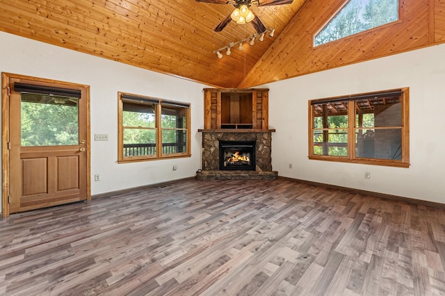 unfurnished living room featuring a fireplace, ceiling fan, wood-type flooring, rail lighting, and high vaulted ceiling