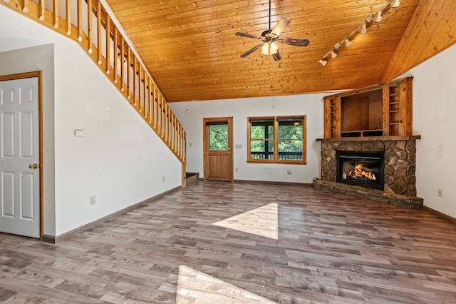 unfurnished living room featuring ceiling fan, wood-type flooring, wooden ceiling, and a fireplace